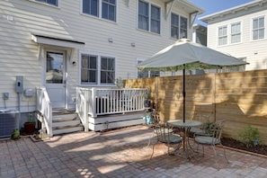 Enjoy a patio area with a porch, garden bed, and seating for outdoor relaxation.