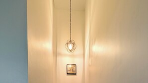 A staircase with wooden steps and white walls, leading to a landing with a framed quote. - Charming Kendall Home in Miami (Miami)