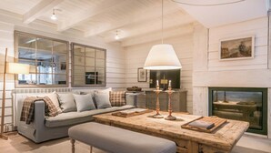 A cozy living room with a wooden table, bench, and a fireplace. - Val de Ruda Luxe 20 by FeelFree Rentals (Val de Ruda)