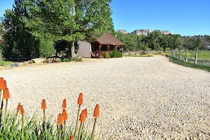Situated in a serene natural setting, this cabin offers a peaceful retreat with a porch and views of the surrounding mountains.