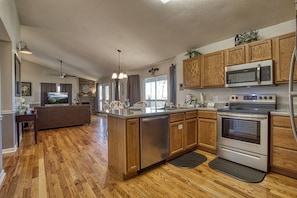 Enjoy cooking in this well-equipped kitchen with a central island, dishwasher, oven, and microwave.