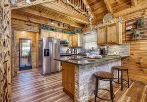 Enjoy casual dining at the kitchen island with an oven and refrigerator.