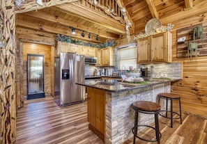 Enjoy casual dining at the kitchen island with an oven and refrigerator.