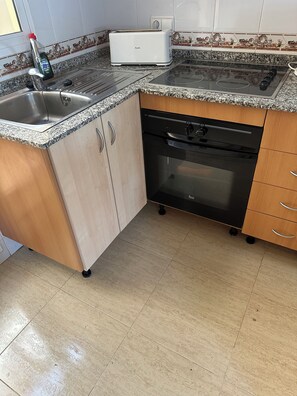 A kitchen with a sink, a toaster, a dishwasher, and a stove. - Spacious Four-floor Luxury Torrevieja Villa,Sea and Park Views, Free Wi Fi. (Torrevieja)