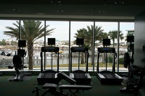Work out with a view of the marina from our modern gym, featuring treadmills, a stationary bike, and a bench.