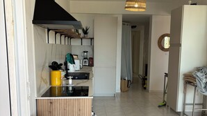 A modern kitchen with a black range hood, a built-in oven, and a wooden countertop.