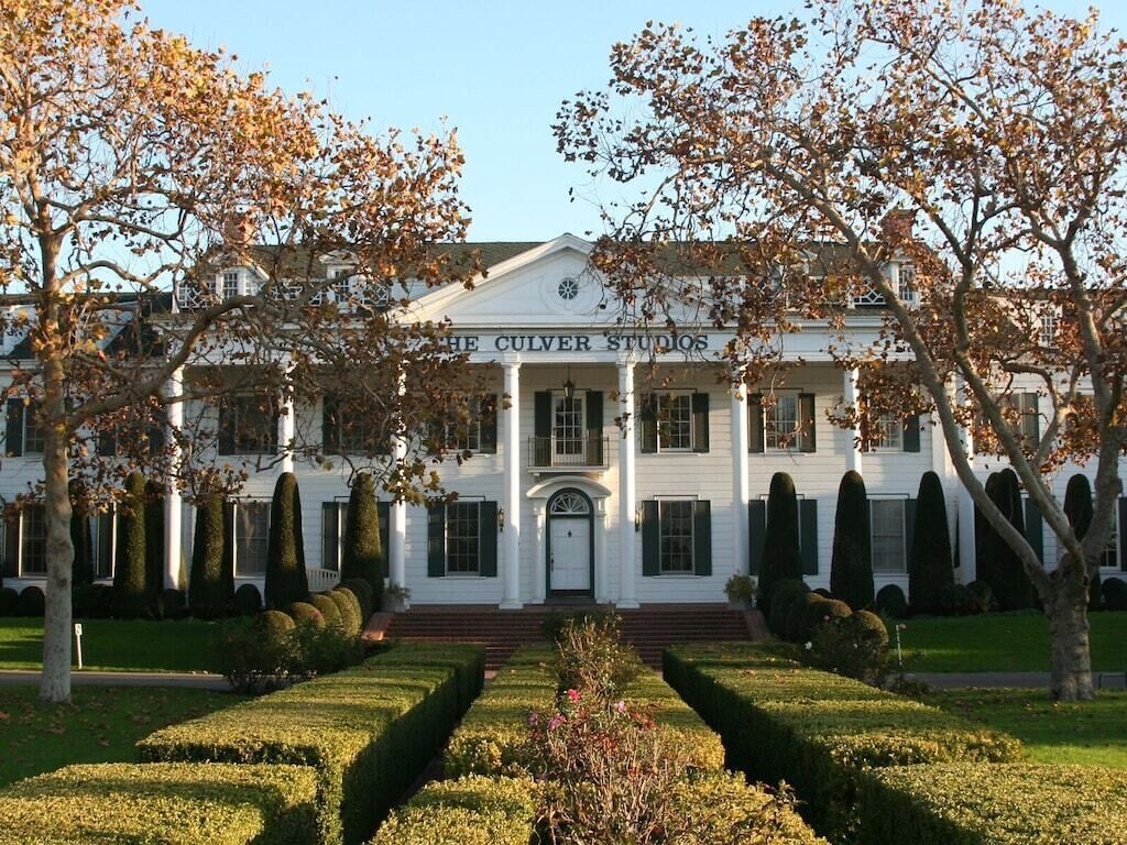 A white building with the sign "The Culver Studios" in front.