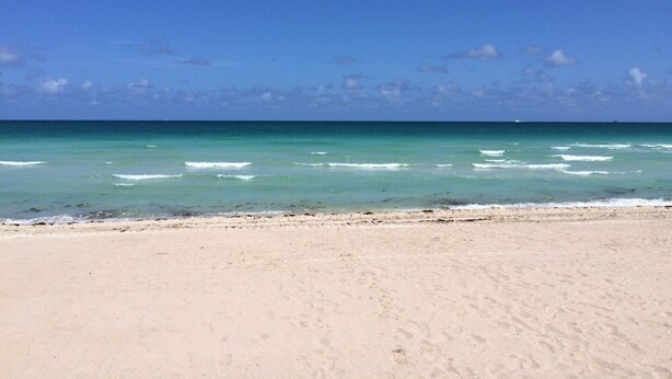 A beach with clear turquoise water and a sandy shore. - Spectacular Views, Great Location on Millionaire's Row (Miami Beach)