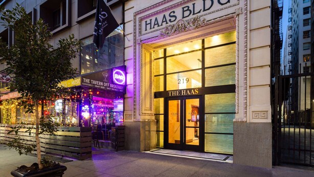 A building with a sign reading "HAAS BLDG" and "THE HAAS" on the entrance. - The Haas, Trademark Collection by Wyndham (Los Angeles)