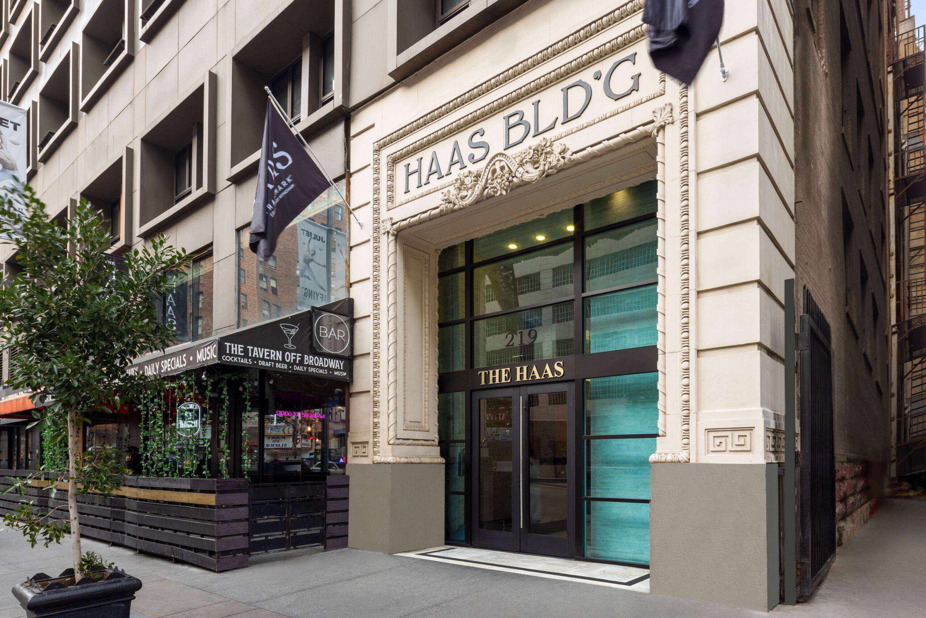 A building with a sign reading "HAAS BLDG" and "THE HAAS" on the entrance.