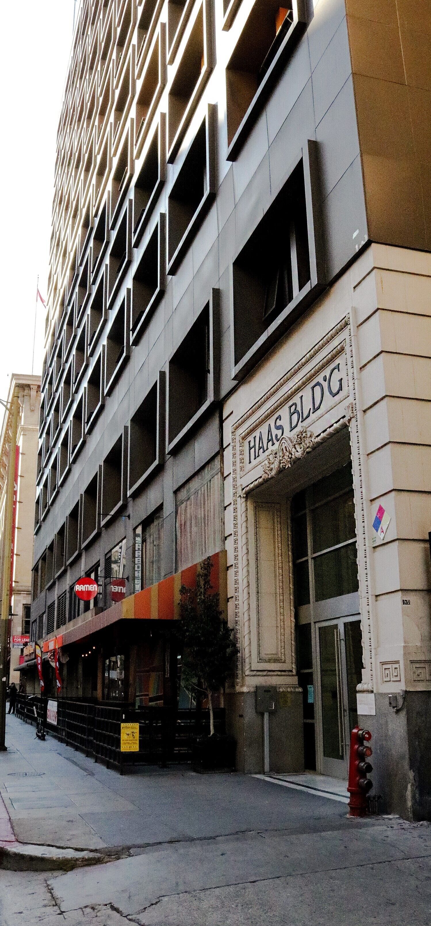 A multi-story building with a sign reading "HAAS BLDG".
