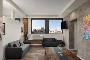 A modern living room with a sofa, a coffee table, and a TV.