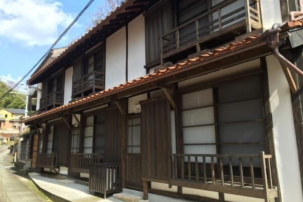 A traditional Japanese building with wooden structures and large windows.