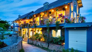 A two-story house with a balcony, a water tank, and a garage. - An Thai Bar & Homestay (Hoa Lu)
