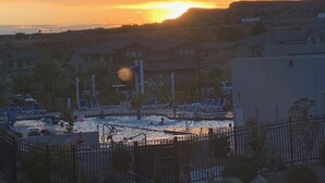 A swimming pool area with lounge chairs and a sunset in the background. - Poolside 4 bdr near OHV Trails w/ Game Room (Washington)