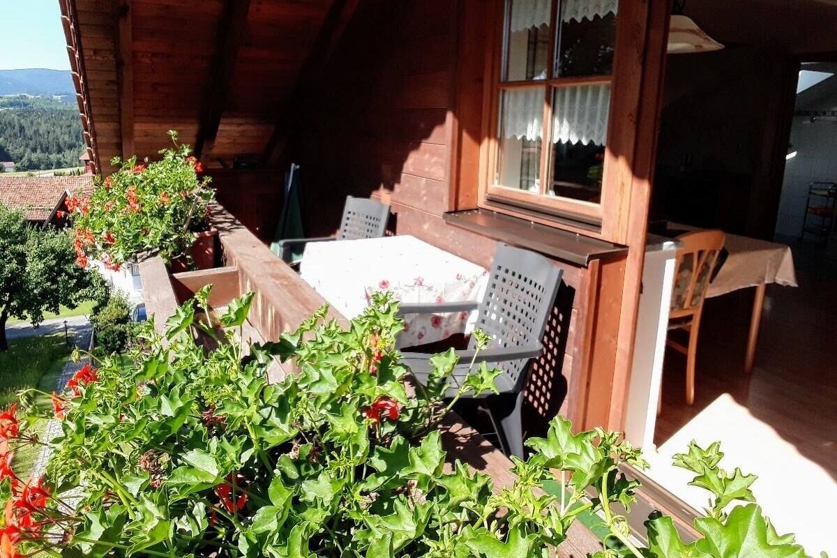 A wooden cabin with a dining area, a table, and chairs.