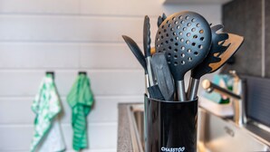 A kitchen utensil holder with various kitchen tools.