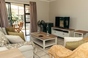Deluxe Apartment, 2 Bedrooms | Living room | 42-inch TV with satellite channels, DVD player, streaming services