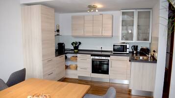 Apartment | Private kitchen | Full-size fridge, microwave, dishwasher, electric kettle