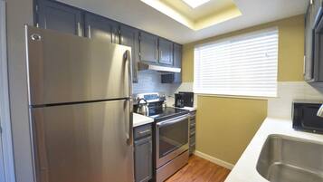 Fridge, microwave, coffee/tea maker, cookware/dishes/utensils