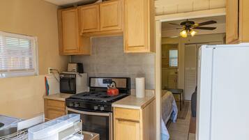 Fridge, microwave, coffee/tea maker, cookware/dishes/utensils