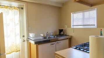 Fridge, microwave, coffee/tea maker, cookware/dishes/utensils