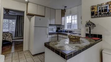 Fridge, microwave, coffee/tea maker, cookware/dishes/utensils