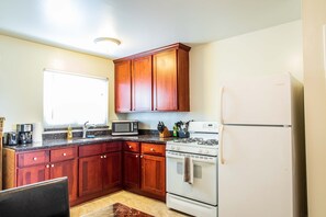 Fridge, microwave, coffee/tea maker, cookware/dishes/utensils