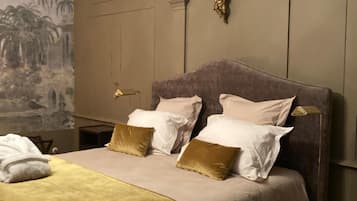 A bed with a headboard, multiple pillows, and a blanket.