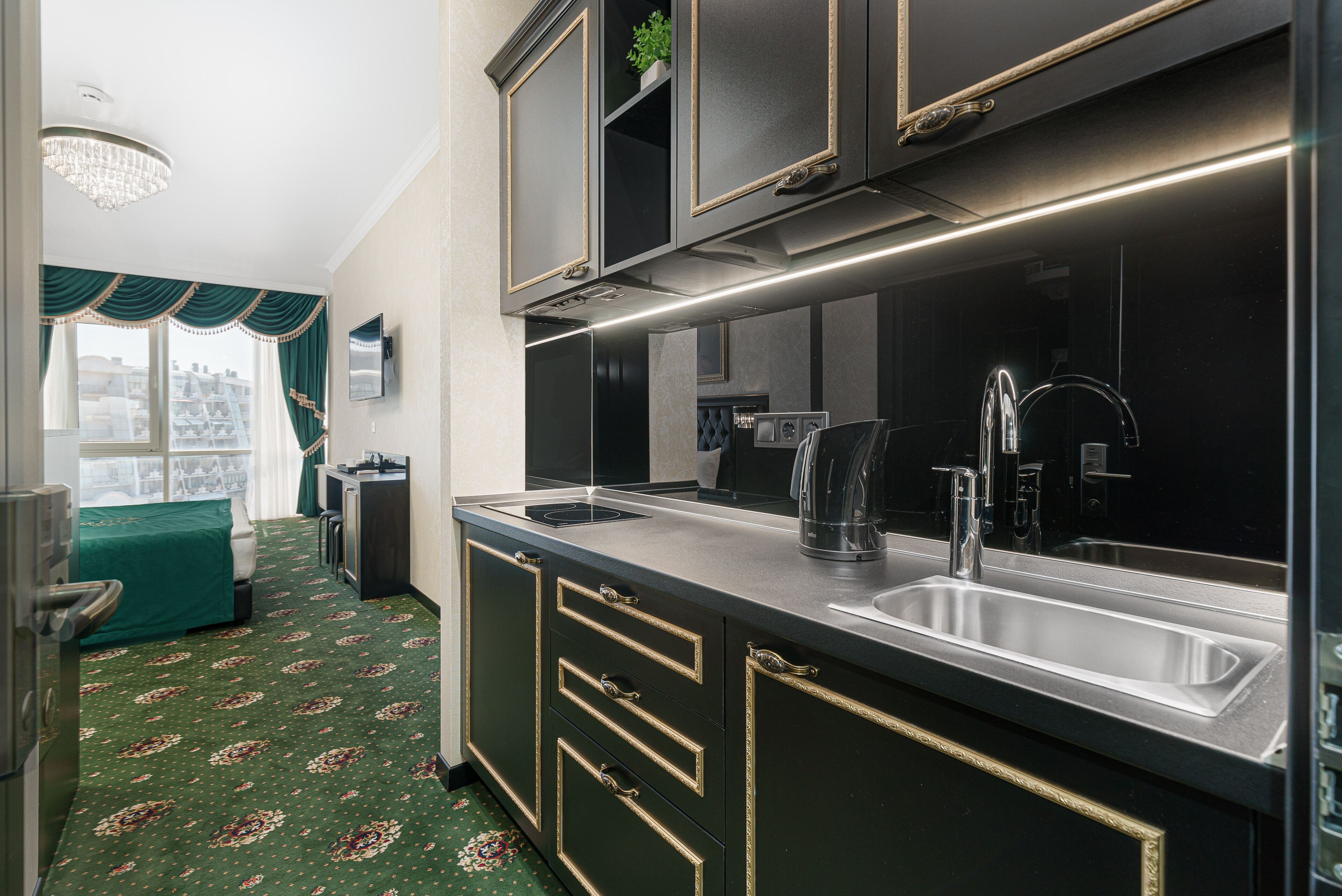A modern kitchen with a large island, stainless steel appliances, and a view of the city.