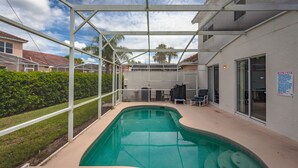 A swimming pool with a covered area, a patio with chairs, and a sign indicating spa rules. - Tuscan Hills-ru1064 (Davenport)