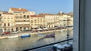 A riverside view with buildings, boats, and people.