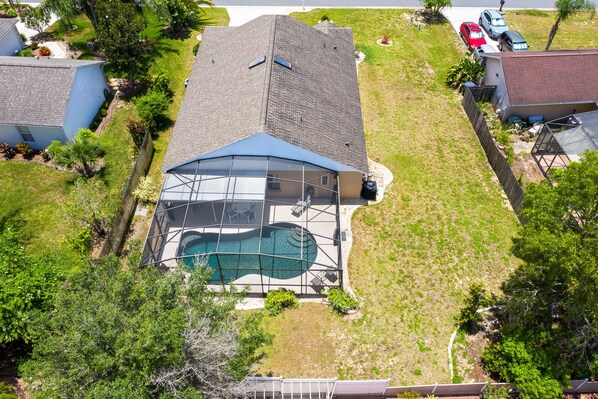 Enjoy a refreshing swim in the covered pool surrounded by a lush lawn.