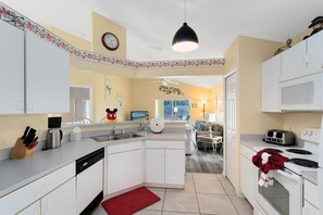 Enjoy cooking in this well-equipped kitchen with a central island, ample counter space, and integrated appliances.