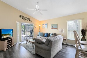 Relax in this cozy living space with a flat-screen TV, comfortable sofa, and dining area.