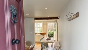 A dining area with a wooden table, chairs, and a bench.