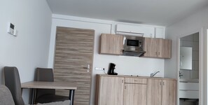 Stovetop, coffee grinder, cookware/dishes/utensils, freezer