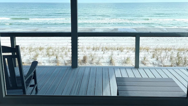 A wooden deck with a view of the ocean and beach. - La Anahi - Oceanfront Vacation Rental (St. Augustine)