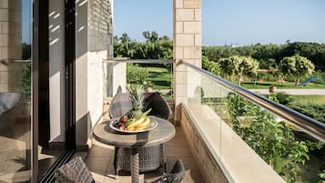 Enjoy dining al fresco on the balcony with a table set amidst a serene landscape view.