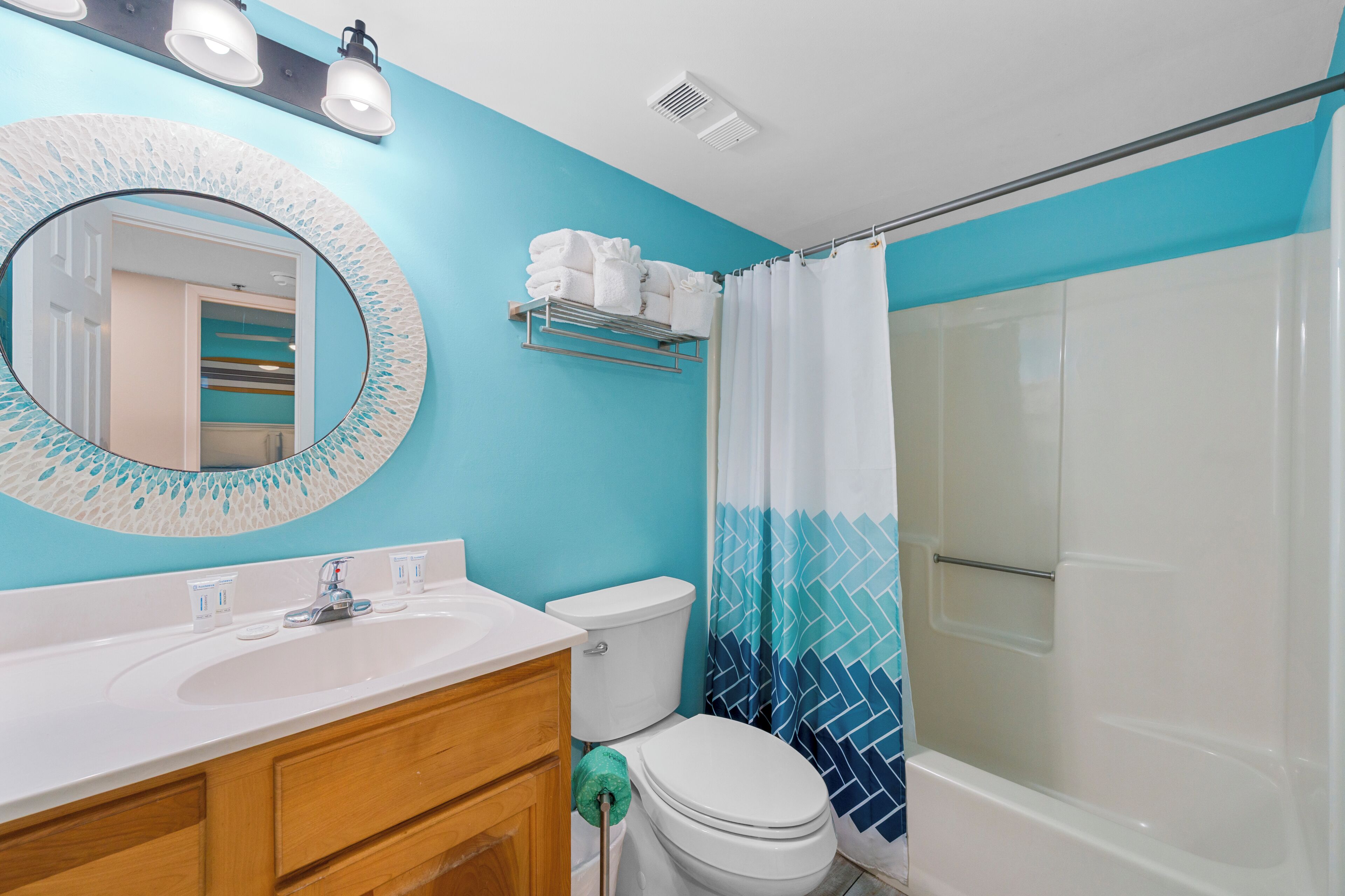 A bathroom with a sink, toilet, and shower.