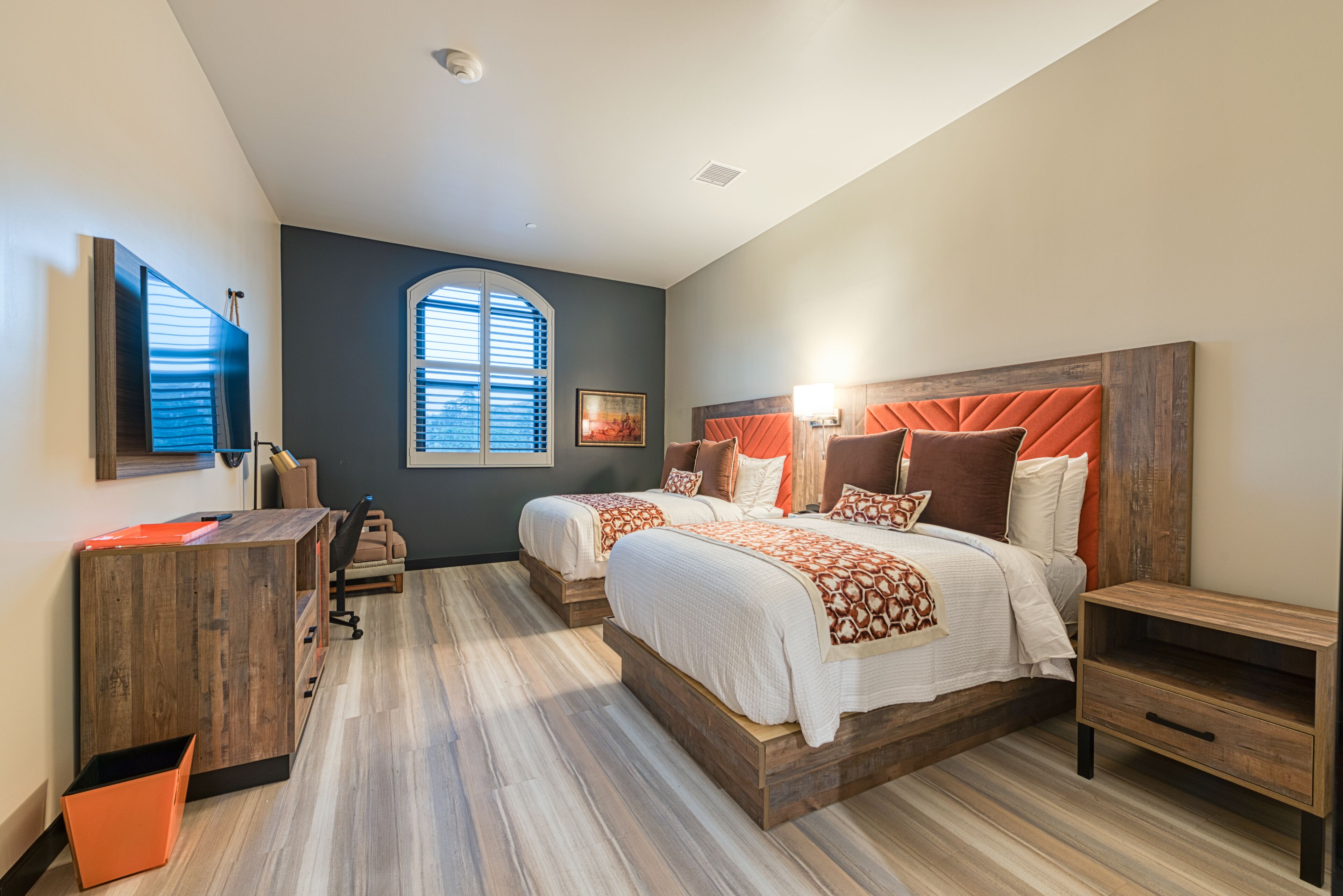 Un dormitorio moderno con dos camas, un escritorio y una silla.