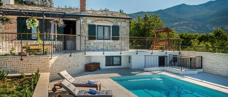 A heated pool, sun loungers