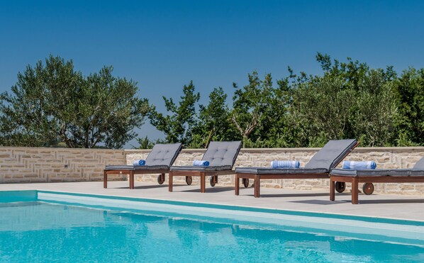 A heated pool, pool loungers