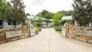 Una entrada cerrada a una zona residencial con muros de piedra y un cartel que dice 'Our Place - Bright'.