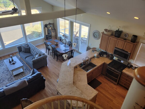 A spacious living area with a dining table, sofa, and kitchen with a built-in oven and microwave. - 3 Master Suites, Spa, Pool table, Game room, views (Tillamook)