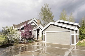Front of house with 2 car parking garage and 2 additional space on front drive.