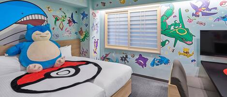 A bedroom with a bed, a plush toy, a TV, and Pokémon-themed wall stickers.