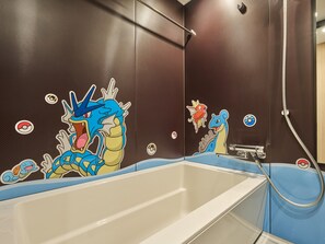 A bathroom with a bathtub, a shower, and a wall with Pokémon stickers. - MIMARU Osaka Namba North (Osaka)