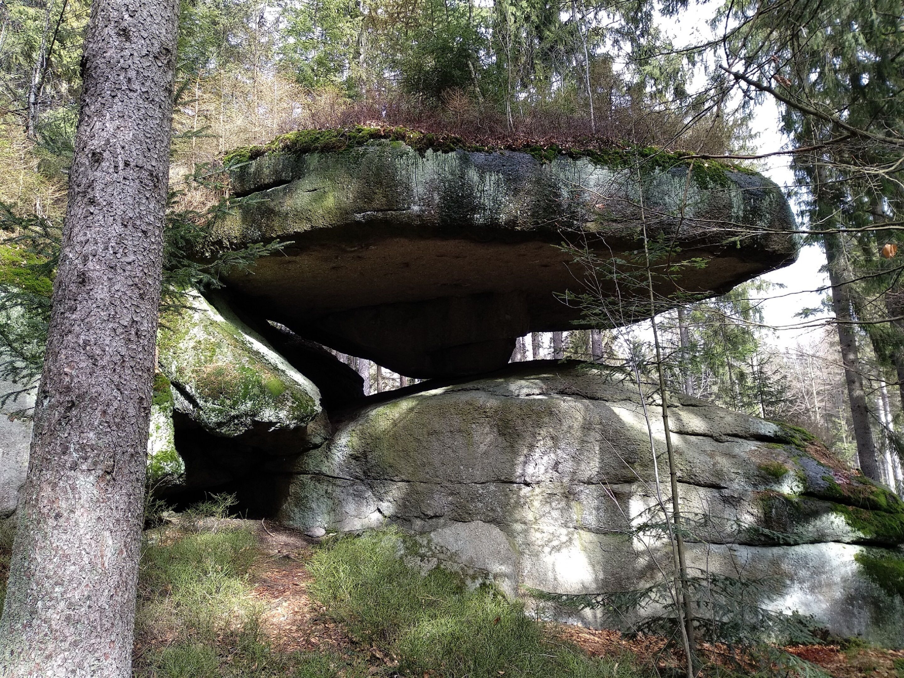 A natural rock formation with a narrow passageway.