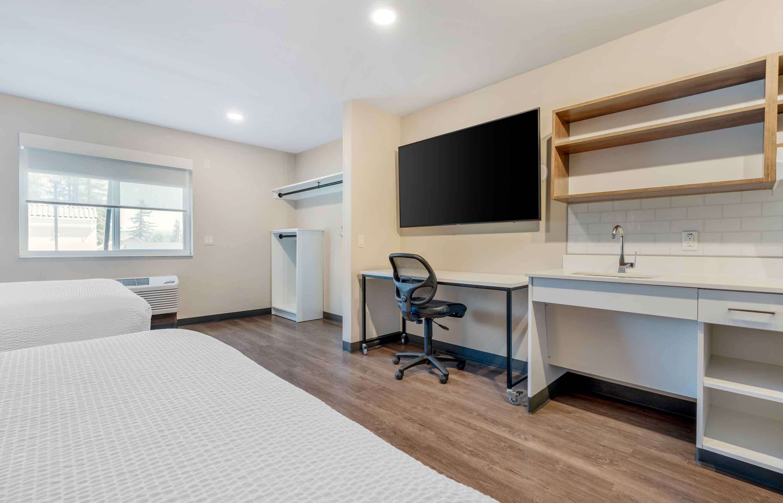 desk, iron/ironing board, bed sheets